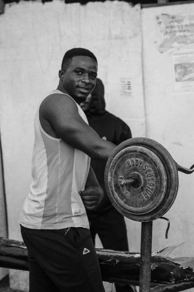 A man lifting weights at an outdoor gym, showcasing strength and fitness.